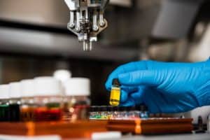 Person holds a test tube inside a lab.